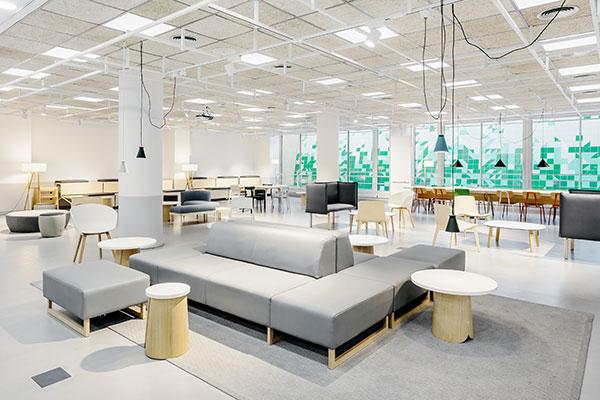 UPF atrium with glass walls, red brick flooring, and natural light from a geometric glass ceiling.