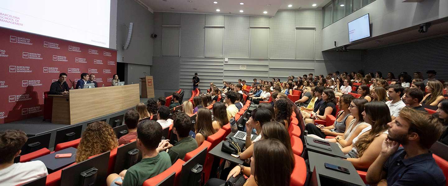 Audience attending a lecture in a university auditorium.