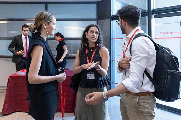 Students networking and talking during a professional event at UPF Barcelona School of Management.