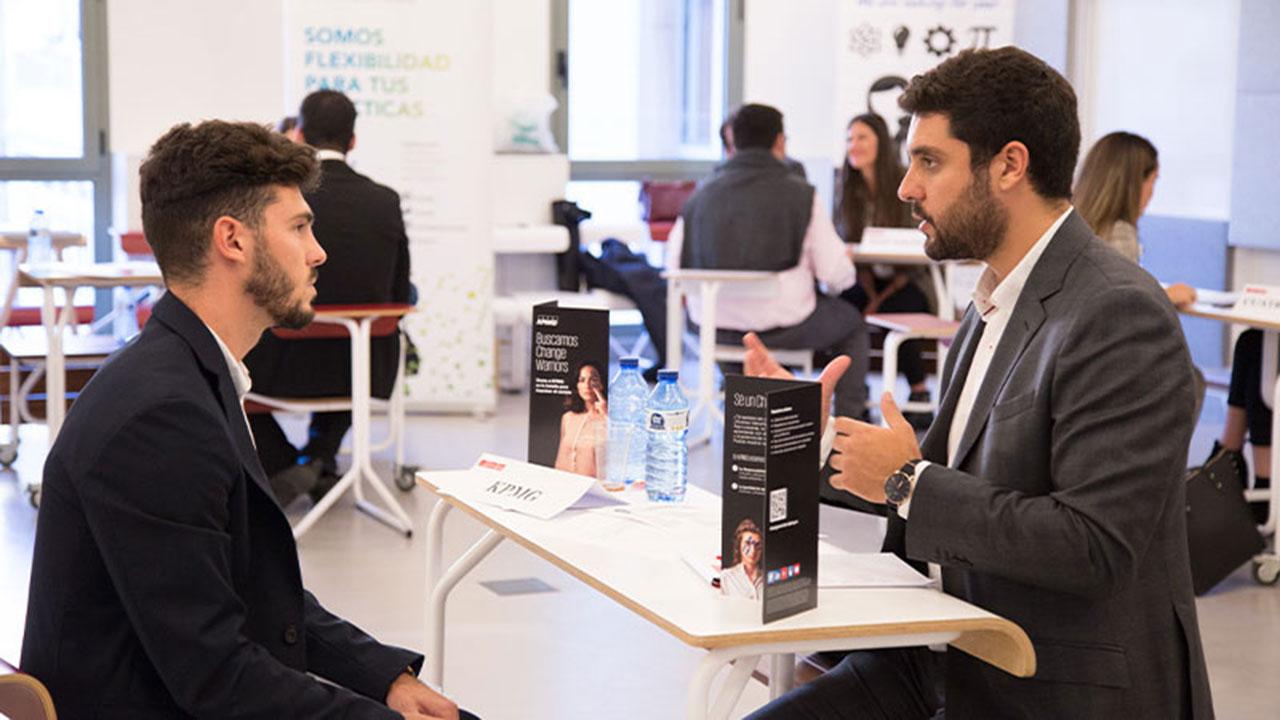 Job interview simulation during Talent Boost Week at UPF-BSM, with two men in professional attire conversing across a table.
